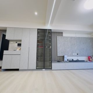 品橙綠雅圖收納牆立面：淺灰色面板與木質格柵裝飾相互映襯的公共區域規劃。